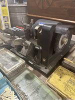 Close-up of Speedex key cutting machine showing cutting mechanism, clamp, and wire brush for deburring keys.