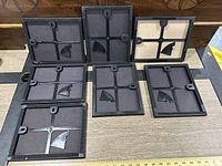 Empty black and beige photo frames showing backing and mounts