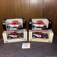 Four boxed die cast Ace Hardware vehicles including two Model A Coupe Chopped Street Rods and two Brandywine Ace Hardware bank trucks on a dark surface with wood background.