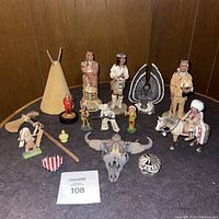 Overview of all Native American and related figurines and decorative items arranged on a table.
