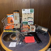 Full lot photo showing sanding papers, saw blades, cordless drill, and car stereo
