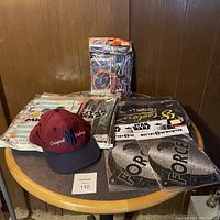 Full view of the lot showing Star Wars and Jurassic World party items with Original Players cap on table.