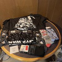 Photo showing Star Wars men's boxer briefs, additional boxer briefs, and Mickey Mouse themed socks on a table