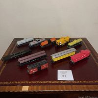 Overview of all ten model train cars displayed on table