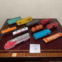 All items in the lot displayed on a table showing the full set of locomotive and freight cars.