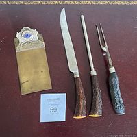 All four items displayed on a dark reddish wood surface with lot number card.