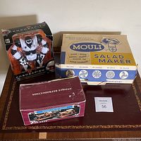 Photo showing all items together: Mouli Salad Maker box, Mini Robosapien toy in packaging, and wooden car pen holder box.