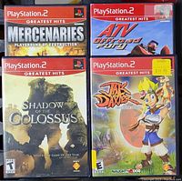 Four PlayStation 2 Greatest Hits games in original cases shown from front: Mercenaries, ATV Offroad Fury, Shadow of the Colossus, Jak and Daxter.