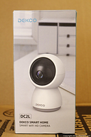 Front view of the Dekco DC2L smart home camera box showing product image and branding.