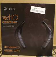 Front view of the Oraolo M110 wearable stereo neck speaker box highlighting product name, explosive bass feature, dynamic sound, flexibility, and 24-hour battery life icons.