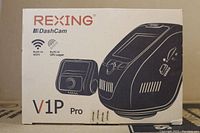 Box showing Rexing branding, product model V1P Pro, image of front and rear cameras, and indication of built-in WiFi and GPS Logger.