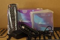 Photo showing the X88 Pro 10 Android TV box with remote control still in plastic wrap, power adapter, and HDMI cable alongside the product box.