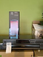 Technics SL-PD847 5-disc CD changer with GenTek wireless LED tower speaker box against green background.