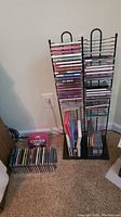 View showing tall and small metal CD racks with various CDs stored horizontally and vertically