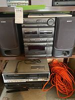 Sony stereo sound system with two speakers on shelf