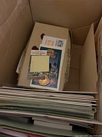 Box of assorted papers and memorabilia including press materials, programs, tickets and cards visible