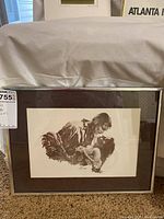 Framed print showing Rhett Butler and Scarlett O'Hara in an intimate pose, matted and framed in silver tone frame with brown matting.