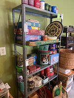 Front angle of the metal shelving unit loaded with various items, showing shelves and frame condition.