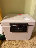 Front view of the SentrySafe 1170 safe showing its rectangular shape, gray color, and black lock panel.
