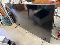 Front view of Samsung TV on stand showing screen and bezel