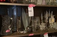 Overall shelf view showing assorted crystal and glass pieces