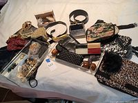 Overhead view of entire lot showing belts, purses, waist bags and jewelry trays