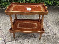 Front view of two-tier wooden serving cart on casters showing top and bottom shelves