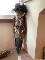 Front view of full mask leaning against wall