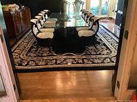 Full view of rug under dining table and chairs showing overall appearance and size relative to furniture