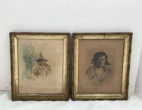 Two gilt-wood framed watercolor portraits side by side against a white backdrop