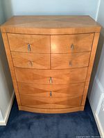 Full front view of bow-front dresser showing diamond veneer pattern and overall shape