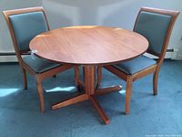 Full view of round table with two chairs
