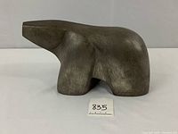 Front side view of stylized polar bear sculpture showing overall shape and surface texture