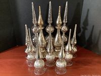 Group photo of all 12 mercury glass decorative tabletop pieces in various shapes, silver tone with some aged patina.