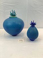 Two ocean wave vessels with urchin lids side by side