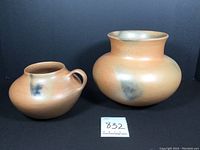 Photo showing both pottery pieces side by side with measurement card