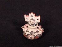 Single miniature pot with crown-shaped finial and painted geometric motifs on black background