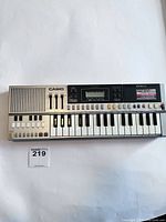 Front view of Casio PT-50 keyboard showing speaker, fader controls, keys and display