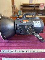 Side view of Courtenay SolaFlash 1000S studio flash head showing the overall size, handle, and reflector.