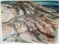 Close-up of canvas surface showing swirling earth tones and blue brushwork