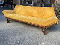Front and angled view of yellow plush gondola sofa showing tufted seat and back with wood frame
