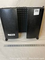 Front view showing the Pyle logo on the perforated panel with legs at the bottom and ruler for size reference.