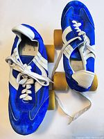 Top view of the pair of blue suede and nylon roller skates showing laces, tongue, and overall design.