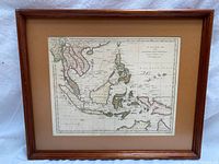 Framed antique map showing geographic area covering Southeast Asia, China, Philippines, New Holland (Australia), and surrounding islands.
