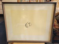 Full view of the framed print showing the artwork of two pears, the frame and glass reflection.
