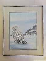 Full view of the framed limited edition print showing a snowy owl in a winter scene, framed in silver metal with cream matte.