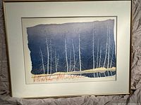 Framed woodcut print showing full artwork with white and gray double mat and gold-tone frame.