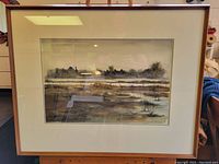 Framed watercolour painting of a rural landscape scene with trees and water, showing overall view including the frame.