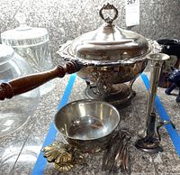 Photo showing the full set including the serving dish with lid and wooden handle, bowl, forks, spoon, and candlestick holder on granite countertop.