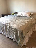 Assembled king bed with sheet set and bed skirt